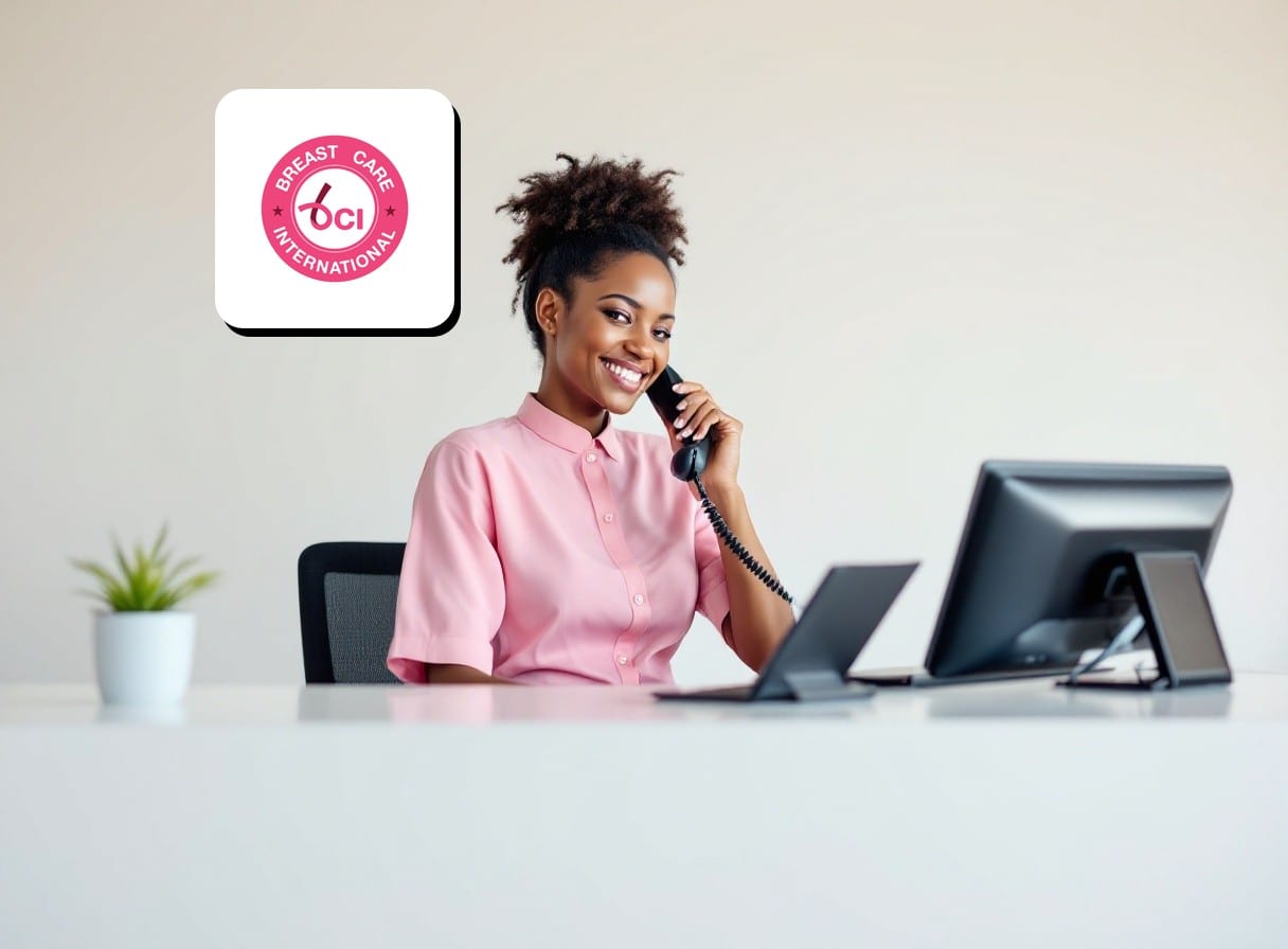 A friendly BCI receptionist in pink answering the phone at a welcome desk below the BCI logo